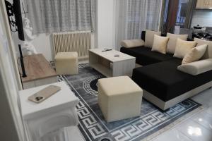 a living room with a couch and a table at Poseidon's Premium Apartment in Katerini