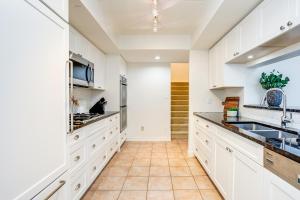 a kitchen with white cabinets and a sink at 3 Bedroom Mountain Walk Condo, Steps to Village in Blue Mountains +8 photos