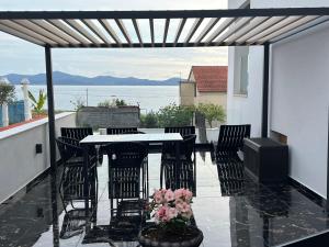 a patio with a table and chairs and a television at Villa Zadar Superior in Zadar +230 photos