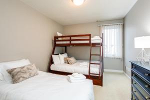 a bedroom with two bunk beds and a desk at 3 Bedroom Mountain Walk Condo, Steps to Village in Blue Mountains
