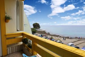 a balcony with a view of the beach at Goden Beach B&B in Eluan