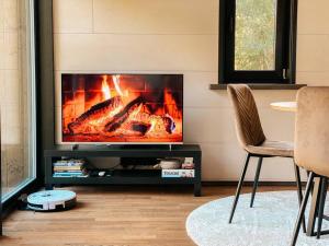 a living room with a fireplace and a chair at Private Stay Zen House to unplug and recharge in Tuimõisa