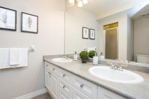 a bathroom with two sinks and a large mirror at 3 Bedroom Mountain Walk Condo, Steps to Village in Blue Mountains