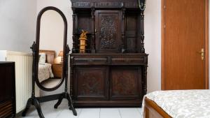 a large wooden dresser in a room with a mirror at Country Side Cozy Villa in Kalabaka