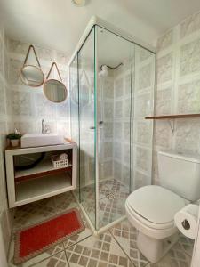 a bathroom with a shower and a toilet and a sink at TINY HOUSE - Privacidade e Vista Exclusiva da Ilha in Palhoça +24 photos
