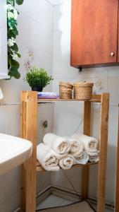 a towel shelf in a bathroom with towels on it at Country Side Cozy Villa in Kalabaka