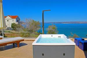 a hot tub on a patio with a view of the ocean at Villa Almy in Plaka