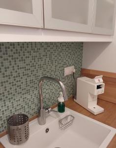 a kitchen sink with a faucet and a counter top at Sweet & Cosy Αpartment in Chora's old town in Andros