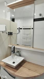 a bathroom with a white sink and a mirror at home, sweet home in Vitry-sur-Seine