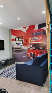 a room with a red double decker bus on the wall at home, sweet home in Vitry-sur-Seine