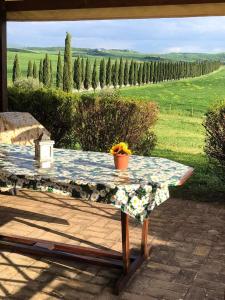 a table on a patio with a view of a field at Casa Country House Girasole vakantie huis-WAKACJE HUIS in Asciano