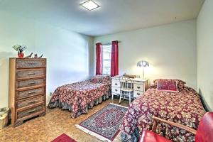 a bedroom with two beds and a desk and a dresser at Mid-Century Hideaway Spacious Brownsville Home! in Brownsville