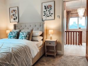 a bedroom with a large bed and a window at Beechwood Park by Solace Stays in Newport
