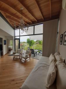 a bedroom with a bed and a living room at Posada Las Aguas in Gualeguaychú