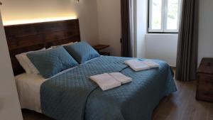 Cama ou camas em um quarto em Quinta do Oratório Agroturismo