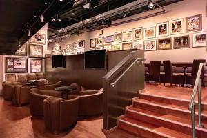 a waiting room with chairs and pictures on the wall at Waikiki Malia in Honolulu