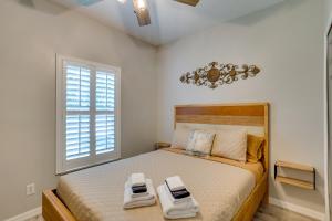 a bedroom with a bed with two towels on it at Renovated Sunny Port St Lucie Home with Outdoor Pool in Port Saint Lucie +31 photos