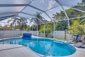a swimming pool with a pavilion on a house at Renovated Sunny Port St Lucie Home with Outdoor Pool in Port Saint Lucie