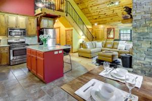 a kitchen and living room with a couch and a table at Beaver Lake Vacation Rental with Private Hot Tub! in Eureka Springs