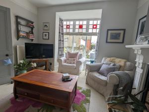 a living room with a couch and a coffee table at Perfect for Snowdon. Groups, families+dogs welcome in Llanberis