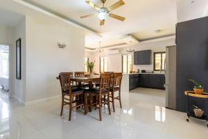 a kitchen and dining room with a table and chairs at Sun Shine Luxury Villas 2 bedroom Pool & Gym Ocho Rios St Ann in Ocho Rios