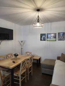 a living room with a table and a couch at Antić apartmani Stara planina in Crni Vrh