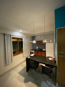 a kitchen with a black table in a room at Pousada Arraial Charme in Arraial d'Ajuda