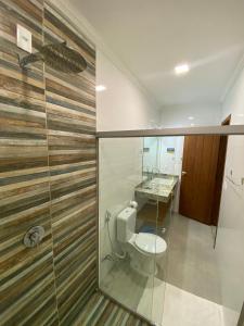 a bathroom with a toilet and a sink at Pousada Arraial Charme in Arraial d'Ajuda