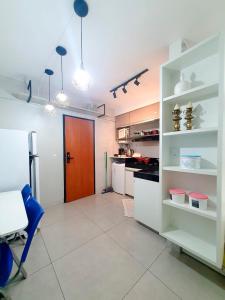 a kitchen with white cabinets and a red door at Apto funcional ao lado da Universidade Catolica in Taguatinga