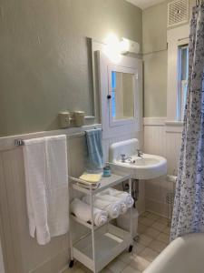 uma casa de banho com um lavatório, um WC e um espelho. em Historic Downtown Riverview Flat, No. 1 em Astoria