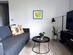 a living room with a couch and a table at Lovely Apartment with 2-bedrooms and living room for 4 guests, max 6 - Seaside Neighborhood in Reykjavík