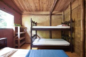 Uma cama ou camas num quarto em Cambuca Surf Skate