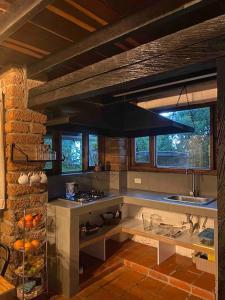 a kitchen with a sink and a stove top oven at Tiny Chalet in the clouds in Medellín