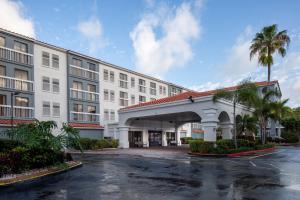 a rendering of the front of a hotel with a parking lot at Holiday Inn & Suites Boca Raton - North in Boca Raton