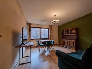 a living room with a table and a dining room at Komfortowy Apartament blisko plaży in Gdańsk