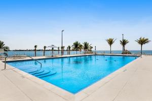 una gran piscina con palmeras y el océano en Tarpon Breeze, en Marathon