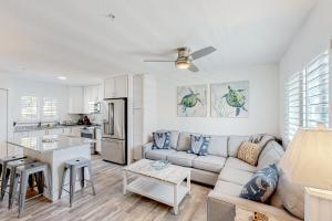 a living room with a couch and a kitchen at Tarpon Breeze in Marathon