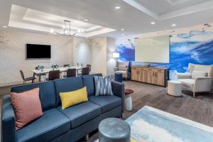 a living room with a blue couch and a table at Crowne Plaza Hotel Los Angeles Harbor, an IHG Hotel in San Pedro