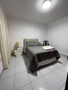 a bedroom with a bed and a white tiled floor at Comfy apartment, best location ! in Tarija