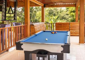 a pool table on a patio with a deck at Senderos del Mar in Buritaca