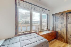 a bedroom with a bed and a large window at Sparkling Glacier - Suite 202 in Columbia Falls