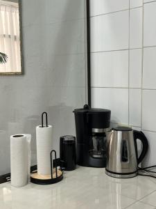 a kitchen counter with a coffee maker and paper towels at Comfy apartment, best location ! in Tarija