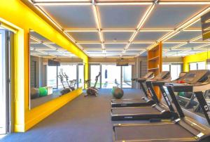 a gym with treadmills and machines in a room at 1002 - Rentaqui Studio Apartamento Lux Pinheiros in Sao Paulo