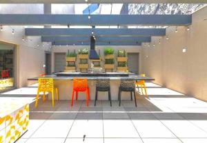 a patio with a table and chairs in a room at 1002 - Rentaqui Studio Apartamento Lux Pinheiros in Sao Paulo