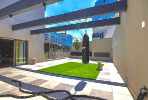 a house with a green lawn in the yard at 1002 - Rentaqui Studio Apartamento Lux Pinheiros in Sao Paulo