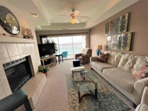 a living room with a couch and a fireplace at Rare GEM @Emerald Bay - Smart Home - THAT VIEW!!! in Lake Ozark