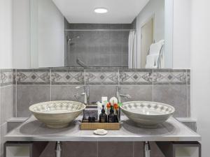 two sinks on a counter in a bathroom at JetPark Auckland Airport Hotel in Auckland