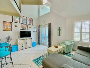 a living room with a couch and a tv at Grand Caribbean 419 by ALBVR - New Owner - Great location in Orange Beach