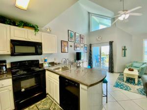 a kitchen with a sink and a stove top oven at Grand Caribbean 419 by ALBVR - New Owner - Great location in Orange Beach