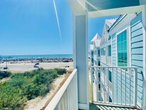 a balcony with a view of the beach at Grand Caribbean 419 by ALBVR - New Owner - Great location in Orange Beach